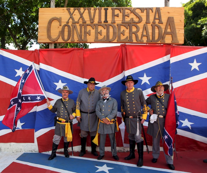 Descendants of American Southerners wearing Confederate-era uniforms pose for a photograph during a party to celebrate the 150th anniversary of the end of the American Civil War in Santa Barbara D'Oeste, Brazil