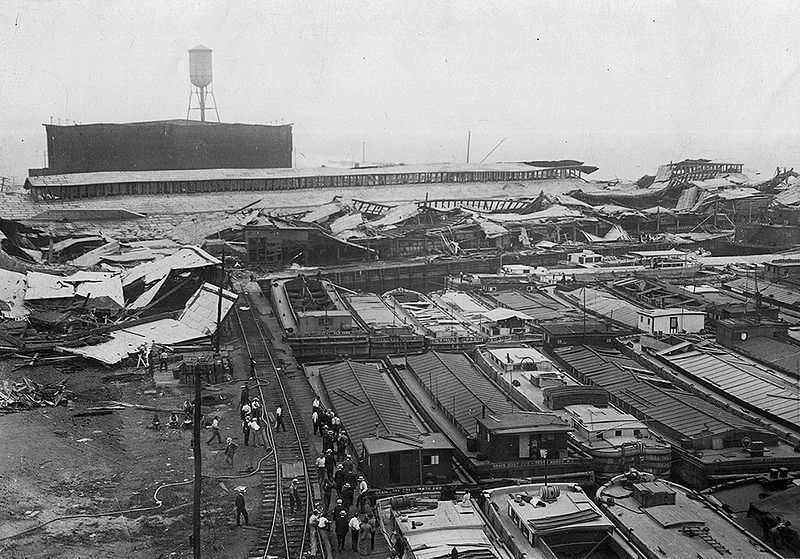 Wrecked_warehouses_and_scattered_debris_after_the_Black_Tom_Explosion,_1916