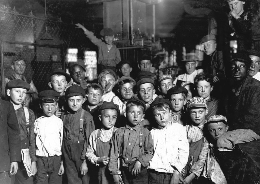 Lewis Hine - Indianapolis Newsboys waiting for the Base Ball edition, in a Newspaper office. Bad environment. Tough negroes etc., 1908